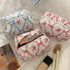 Portable cosmetic pouch with bow detail, ideal for skincare storage.