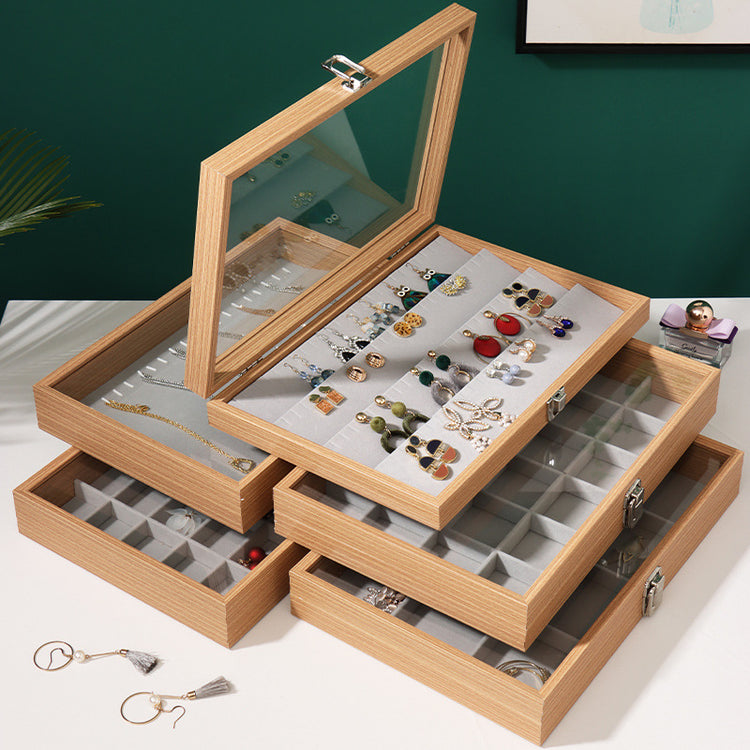 Open rosewood jewelry box displaying neatly arranged accessories